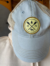 Load image into Gallery viewer, Light blue hat with patch featuring cross paddles, moose, and tree
